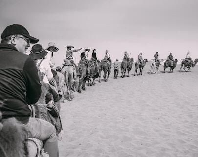 A line of horseback riders following the leader.